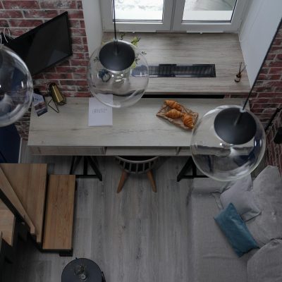 Aerial view of a modern loft featuring croissants and stylish lighting.